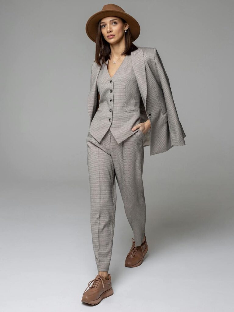 From The Spring Work Wear Edit, a woman wearing a brown hat in a grey three-piece suit.