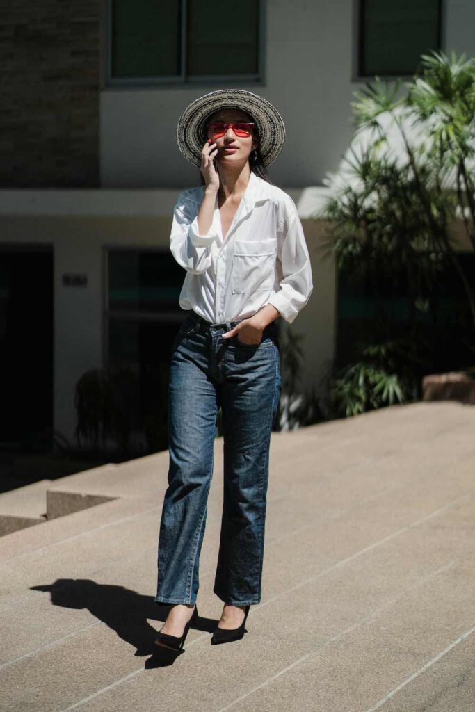 Smart casual street-style featuring a white shirt, straight-leg jeans, and heels for modern blazer outfits for women.