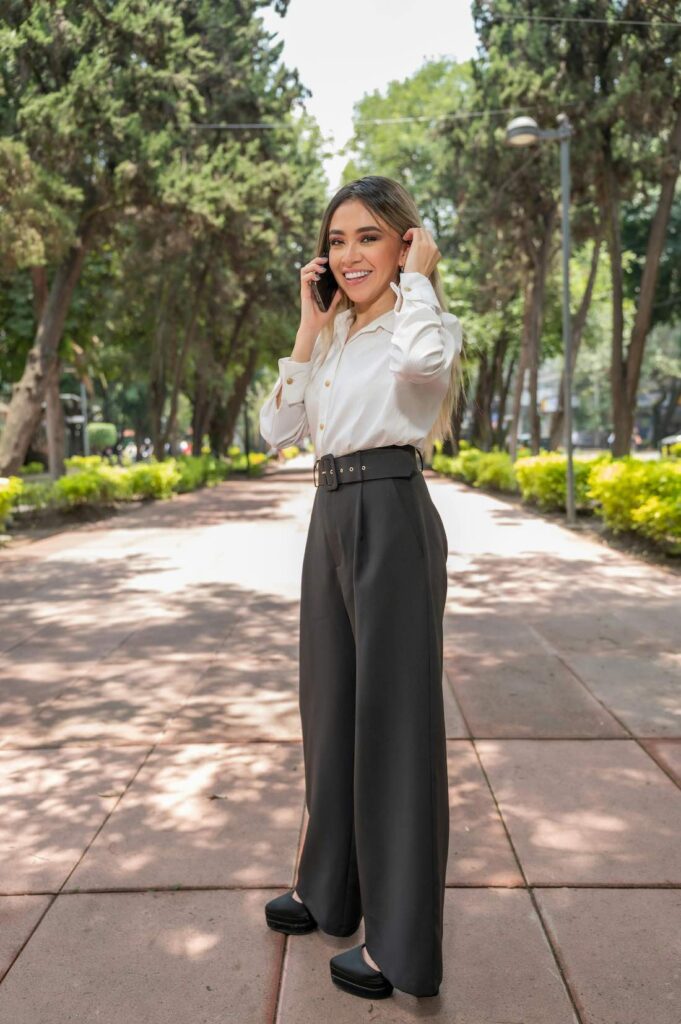 Elegant white blouse and belted wide-leg trousers to pair with a structured modern blazer.