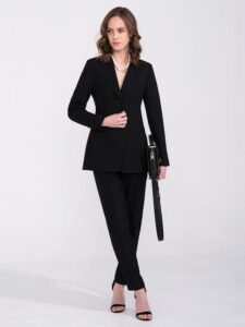 Model wearing a sharp black modern blazer and tailored trousers for a sophisticated women's professional edit.