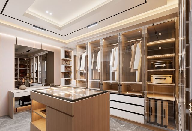 A minimalist modern walk-in closet with warm LED lighting, glass-front wardrobes, and organised neutral classic clothing items.